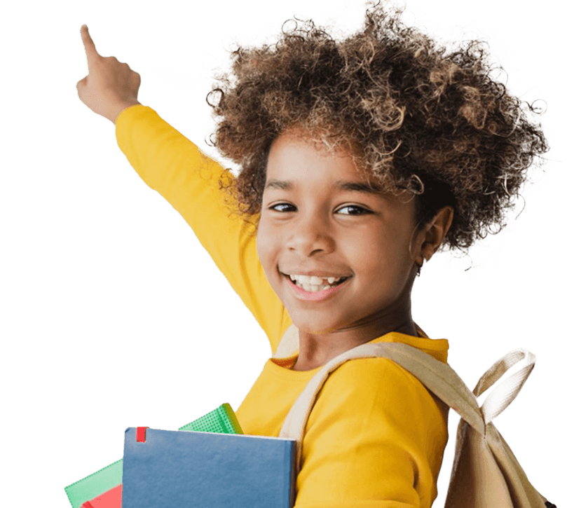 A young Black girl wearing a canvas backpack and carrying schoolbooks smiles and points outwards