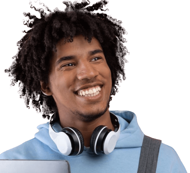 A black man wearing a light blue hoodie and headphones around his neck smiles broadly